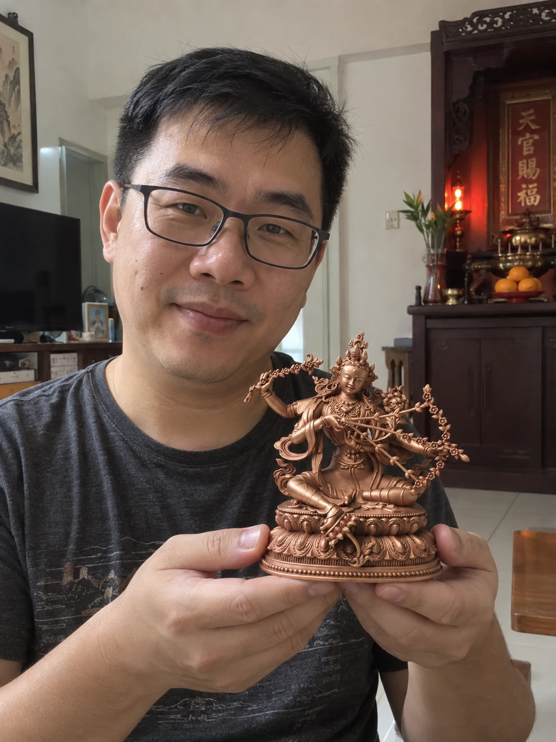 Kurukulle (Red Tara) statue held in a home setting