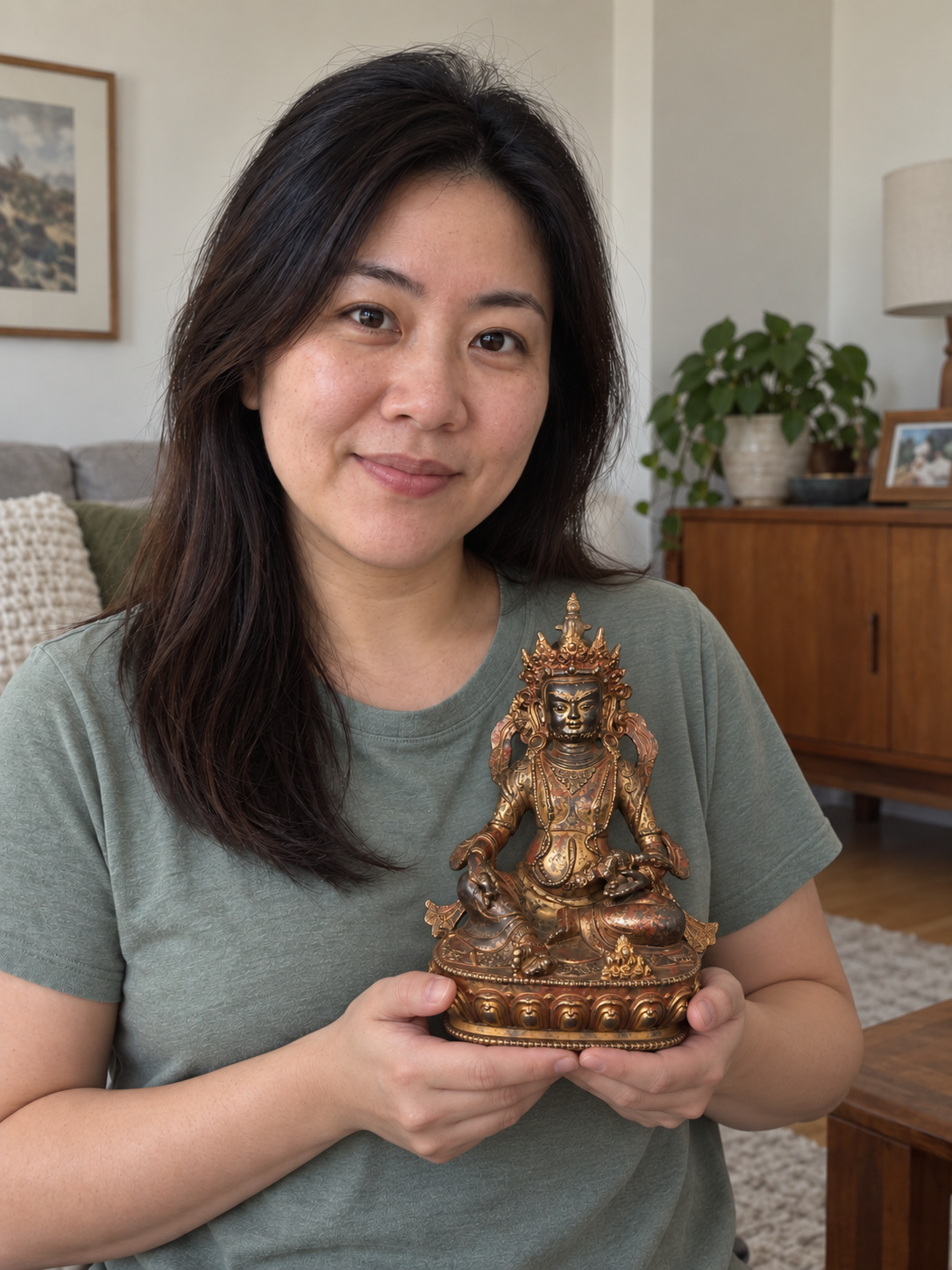 Vajrasattva statue held in a home setting